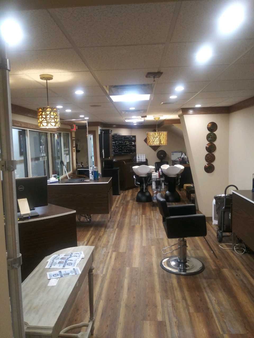 Anthony Fredrick Salon styling floor with stylist chairs and gold-framed mirrors in Dedham, MA
